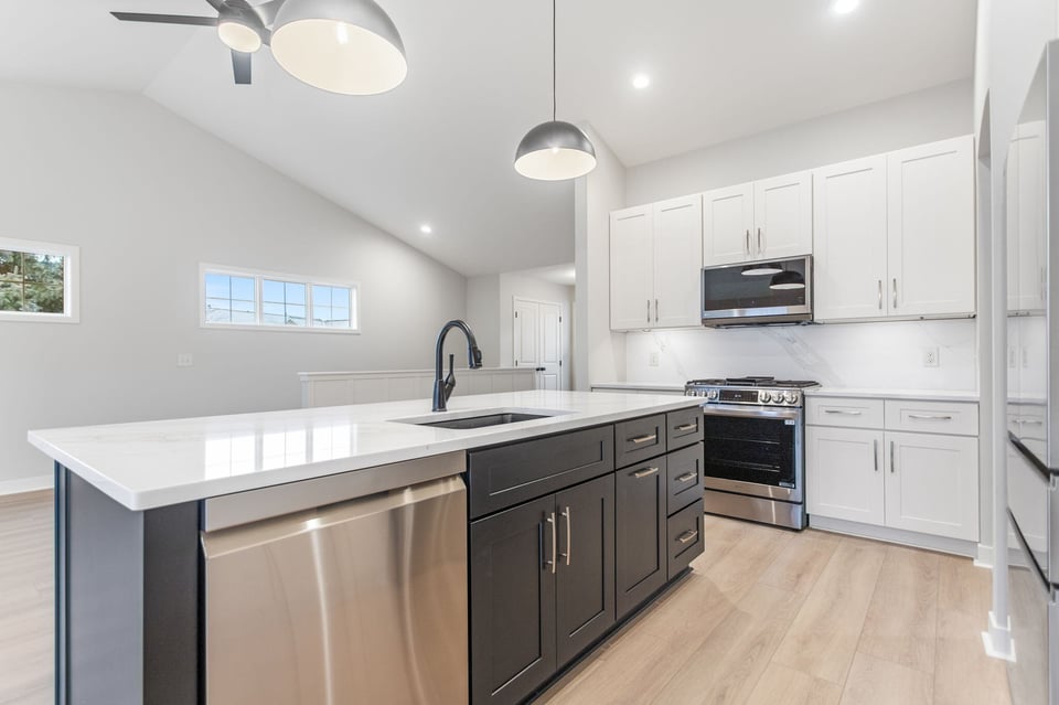 kitchen remodel in grand rapids with white cabinets, gray island, and stainless steel appliances