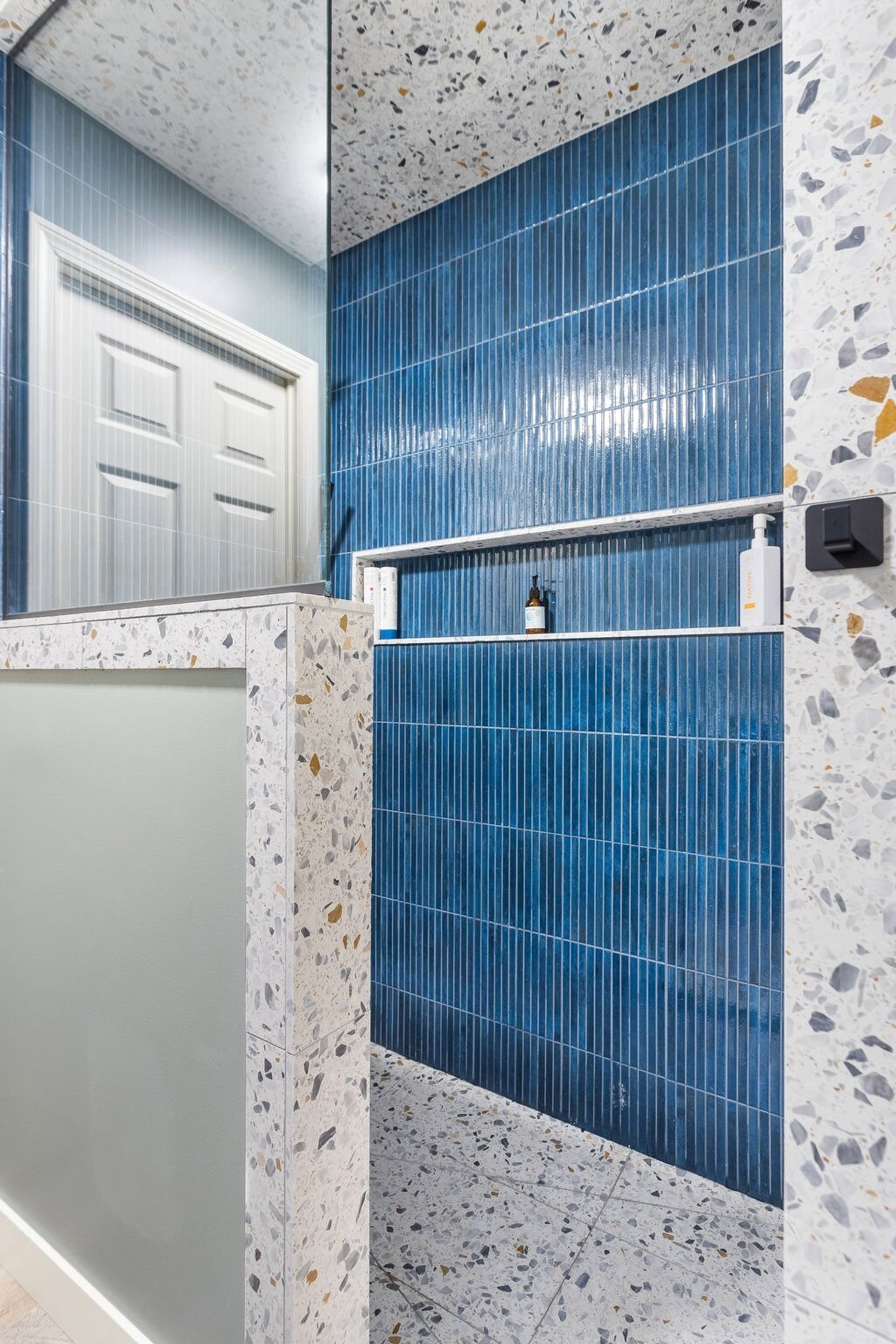 bathroom remodel in grand rapids with statement blue shower tile 