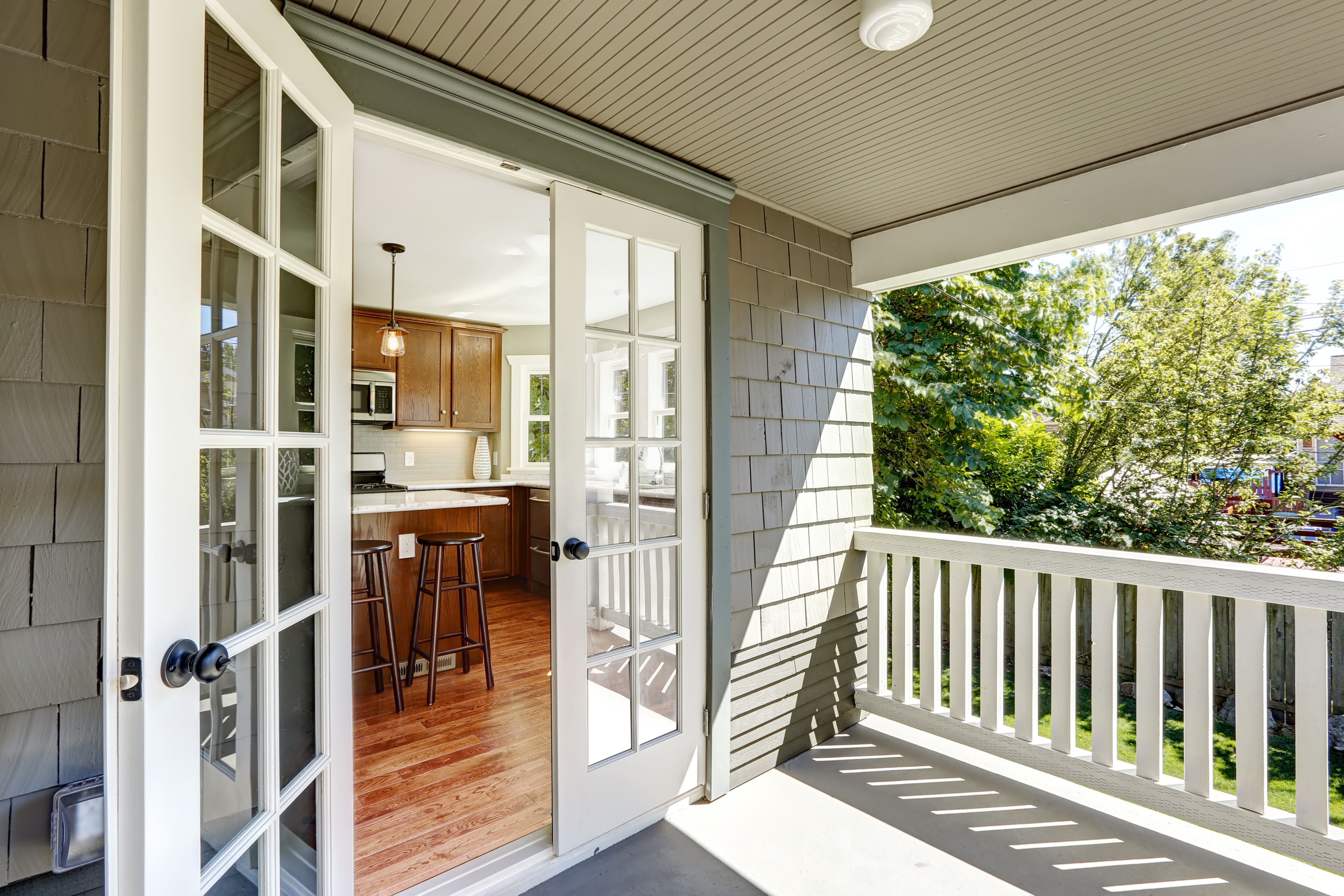 home remodel in grand rapids michigan with french doors, covered deck, and kitchen with island~mv2